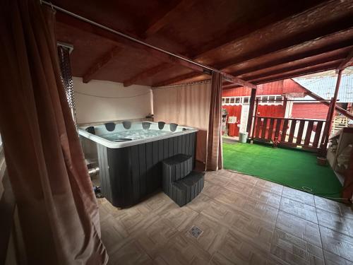 a bath tub in a room with a green yard at Pensiunea Daiana in Albac