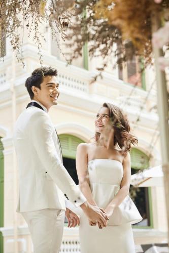 a bride and groom standing next to each other at W Bangkok Hotel in Bangkok