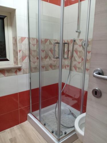 a glass shower in a bathroom with a toilet at Blue House in Pizzo