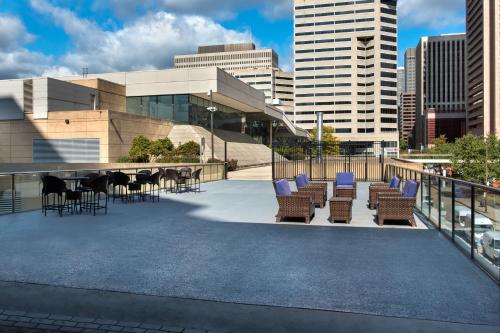 a patio with chairs and tables and a building at Sheraton Inner Harbor Hotel in Baltimore