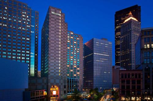 a group of tall buildings in a city at night at The Westin Pittsburgh in Pittsburgh