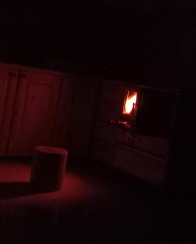 a dark room with a small light in a window at Chalet Čilac in Žabljak