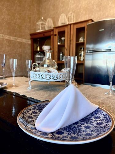 a table with a plate with a napkin on it at Casa da Lagoa in Tramandaí