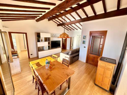 a kitchen and living room with a wooden table at Kiss of sea - Balzi Rossi & Baia Beniamin in Ventimiglia