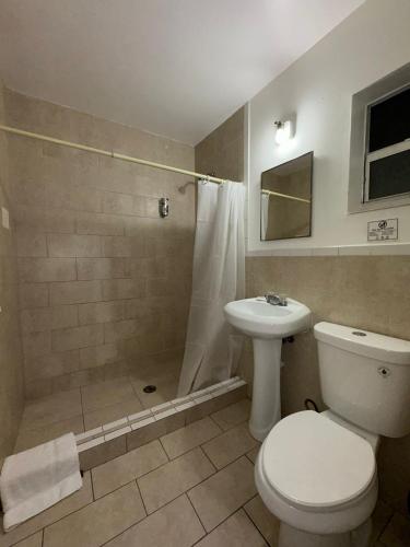 a bathroom with a toilet and a shower and a sink at Hotel Rainbow - Miami - Little Havanna in Miami