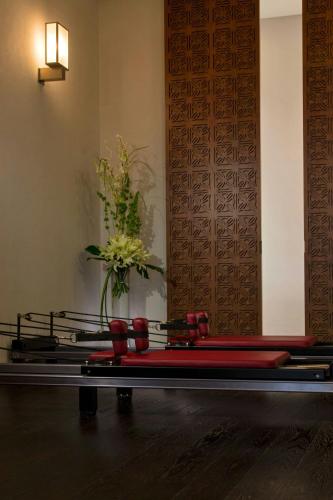 a row of red seats in a room with a vase at The St. Regis Mexico City in Mexico City