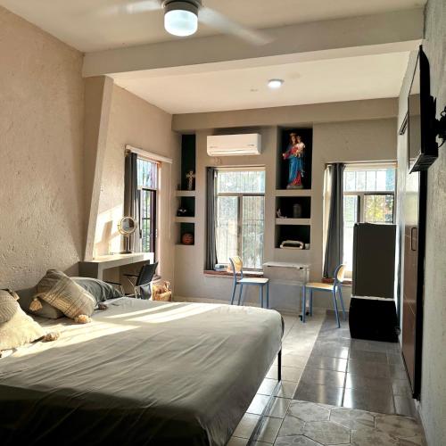 a bedroom with a large bed and a dining room at Habitaciones Dos Antonios in Puerto Vallarta