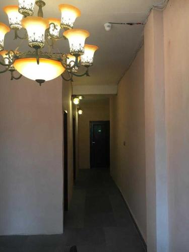 a chandelier hanging from a ceiling in a hallway at Hotel O The Limestone in Indraprast