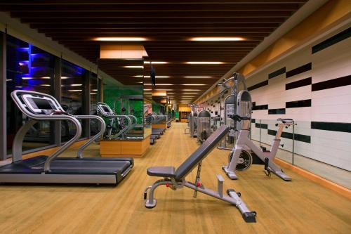a gym with treadmills and elliptical machines at The Westin Pune Koregaon Park in Pune