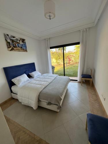 a bedroom with a large bed and a large window at Villa 228 Dyar Shemsi in Taroudant