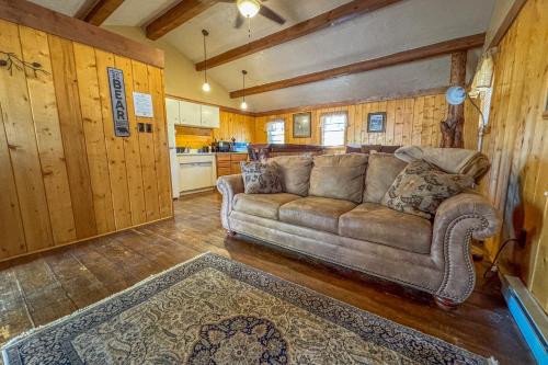 a living room with a couch and a kitchen at Chinook Winds Lodge in Dubois