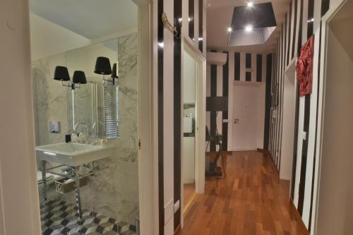 a bathroom with a sink and a mirror at Piano Suite in Vatican in Rome
