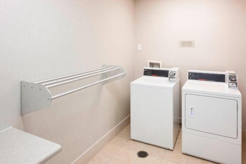 a laundry room with a washer and a dryer at SpringHill Suites Columbus in Columbus