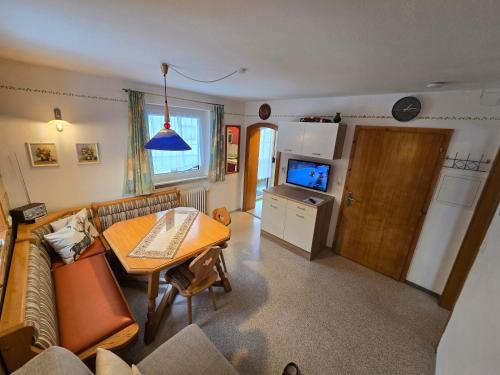 a living room with a couch and a table at am Mühlbach - Ferienwohnungen Luttinger in Bichlbach