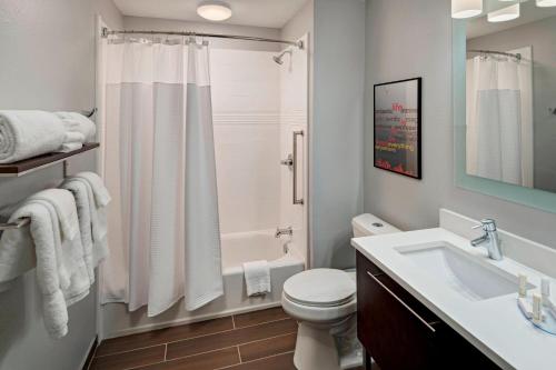 a bathroom with a toilet sink and a shower at TownePlace Suites by Marriott Baton Rouge Port Allen in Port Allen