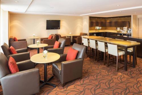 a restaurant with tables and chairs and a bar at Sheraton Vancouver Airport Hotel in Richmond