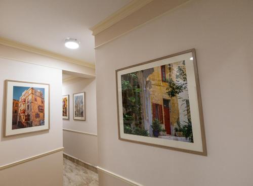 a hallway with paintings on the walls of a museum at Luxurious & Spacious 2BD Penthouse with Large Terrace & Jacuzzi at The Podium - Yacht Marina Area, Close to Valletta in Msida
