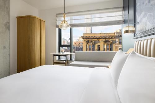 a bedroom with a white bed and a window at Timbri Hotel San Francisco, Curio Collection by Hilton in San Francisco