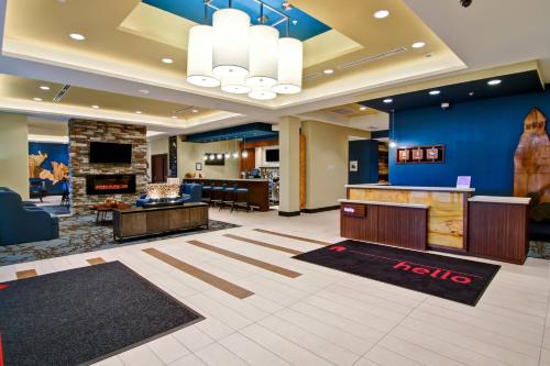 a lobby of a hotel with a waiting area and a reception desk at TownePlace Suites by Marriott Kincardine in Kincardine