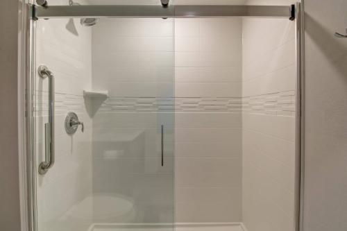 a shower with a glass door in a bathroom at TownePlace Suites by Marriott Kincardine in Kincardine