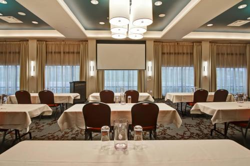 a conference room with tables and a projection screen at TownePlace Suites by Marriott Kincardine in Kincardine