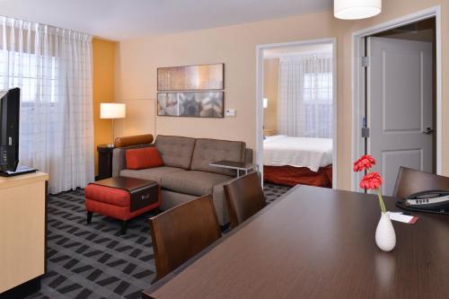 a living room with a couch and a table at TownePlace Suites by Marriott Las Vegas Henderson in Las Vegas
