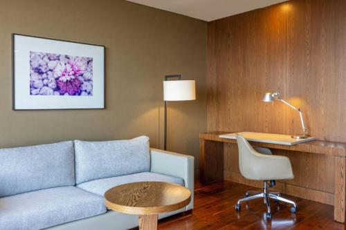 a living room with a couch and a table and a desk at The Westin Santa Fe, Mexico City in Mexico City