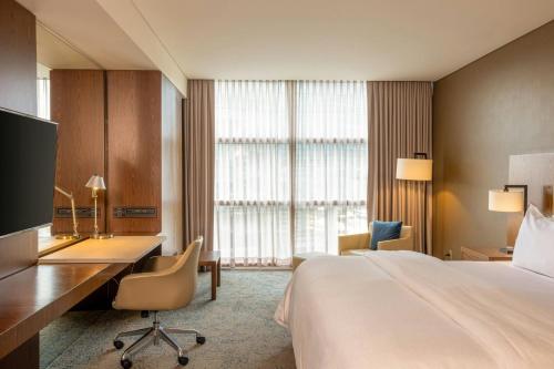 a hotel room with a bed and a desk and a computer at The Westin Santa Fe, Mexico City in Mexico City