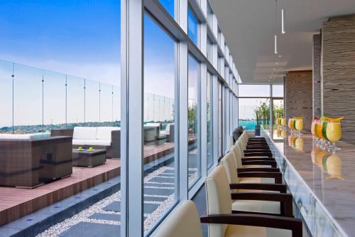 a row of chairs in a building with windows at The Westin Santa Fe, Mexico City in Mexico City