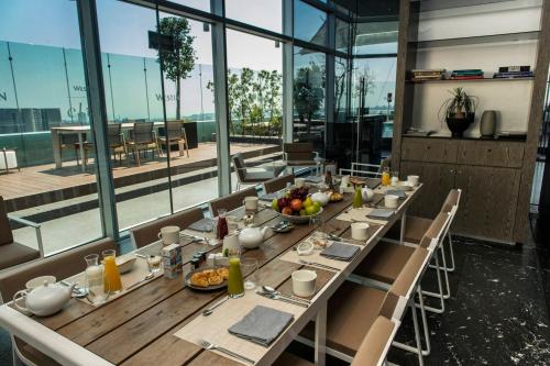 a dining room with a long table with food on it at The Westin Santa Fe, Mexico City in Mexico City