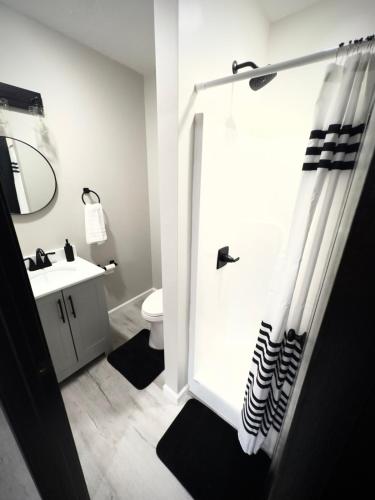 a bathroom with a shower with a sink and a toilet at Luxury Modern Gatlinburg Cabin Hot Tub and Sauna in Gatlinburg