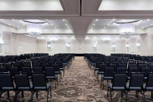 an empty room with chairs and chandeliers at Le Meridien Charlotte in Charlotte
