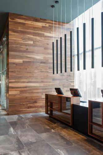 an office with a wooden wall and a desk at Le Meridien Charlotte in Charlotte