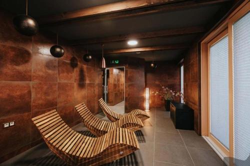 a lobby with three chairs in a room at PanorámaX12 Hillside apartmán in Dolný Kubín