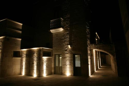 a building with lights on it at night at Corte Dei Granai Meeting & SPA - Raro Rooms Collection in Maglie
