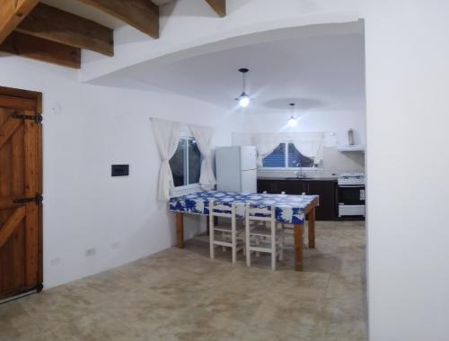 a kitchen with a table and a refrigerator at Casa Praga in Ostende