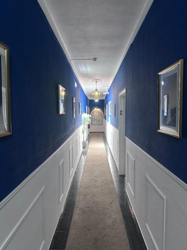 a hallway with blue walls and a hallway with a hallwayngth at Arcada House Tavira in Tavira