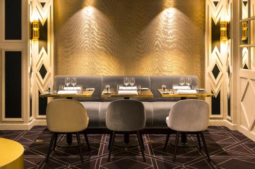 a dining room with a long table and chairs at Hotel Barsey by Warwick in Brussels