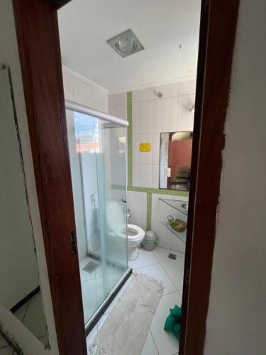 a bathroom with a glass shower and a toilet at Hostel Preservar in Cabo Frio