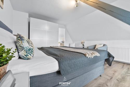 a bedroom with a large bed in a white room at Apartment 25 in Kappeln