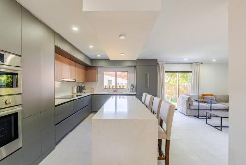 a kitchen with a large white table and chairs at Miami Oasis by Brickell and Beaches in Miami