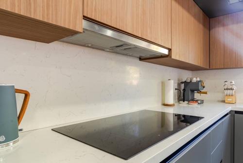 a kitchen with wooden cabinets and a counter top at Miami Oasis by Brickell and Beaches in Miami