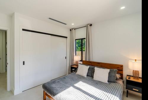 a bedroom with a bed and a large window at Miami Oasis by Brickell and Beaches in Miami