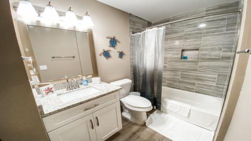 a bathroom with a sink and a toilet and a shower at Charming 1BR Getaway - Private, Pet Friendly, TV in Texas City