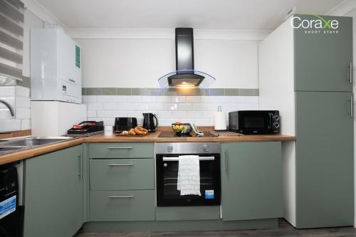 a kitchen with a sink and a stove top oven at 2 Bedroom Cosy retreat in West Thurrock