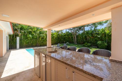 an outdoor kitchen with a view of a backyard at Casa Linda Villa 918 - Sosua in Sosúa