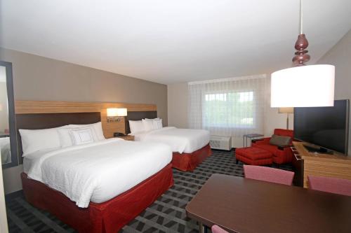 a hotel room with two beds and a flat screen tv at TownePlace Suites by Marriott Charleston-North Charleston in Charleston