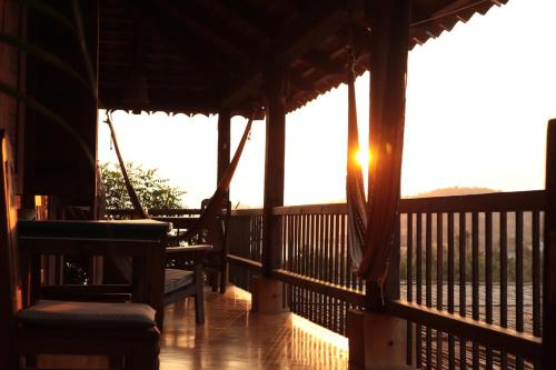 a porch with the sun shining through the windows at LA LOMA LINDA, Bungalows, Yoga and Feldenkrais, STARLINK INTERNET in Zipolite