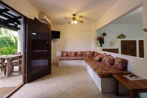 a living room with a couch and a table at Condiminium Villas Mymosa in Manuel Antonio