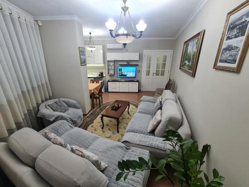 a living room with two couches and a tv at Tirana Center in Tirana
